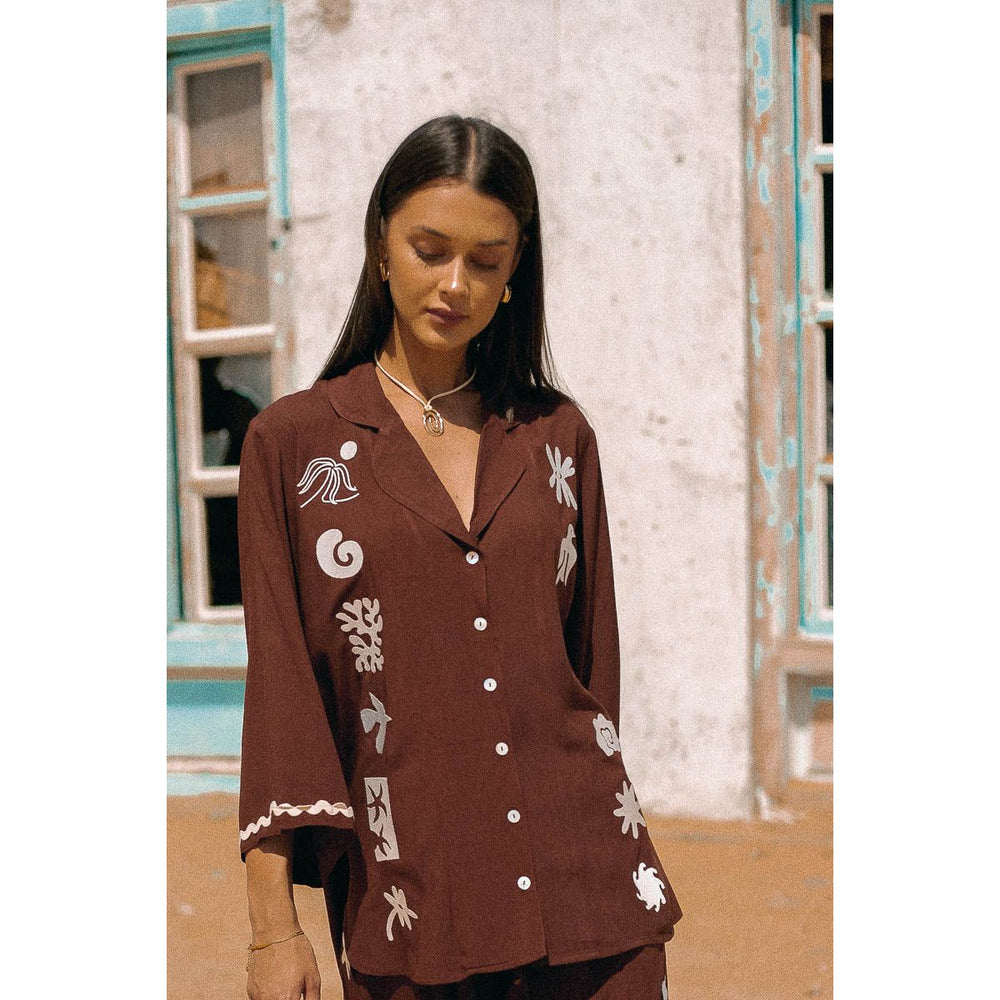 The Sierra Shirt is a rich chocolate show stopper! Featuring an embroidered motif detail,&nbsp; made from soft eco rayon fabric and with a relaxed fit, its a Spring/Summer must have. Perfectly matched with the Romi Pants for the ultimate set duo.&nbsp;

Features:

Relaxed fit&nbsp;
100% Eco Rayon fabric
Flared sleeves
Embroidered detail down front
Zig zag trim detail on sleeve cuff
Shell Buttons