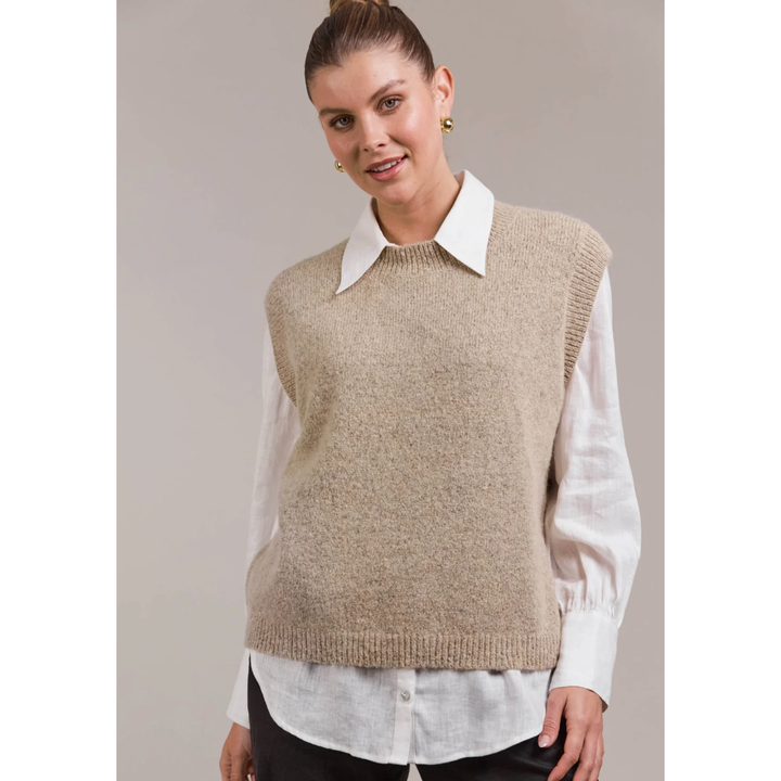 Folie Vest-OAT

The Folie Vest brings timeless sophistication to your knitwear collection. With a sleek crewneck, sleeveless cut, and hip-length fit, this vest is designed to keep things simple yet stylish. Made from a plush wool blend, it provides warmth and comfort throughout the season. Whether styled solo or layered over a shirt, blouse, or dress, the Folie Vest adds instant polish to any look.