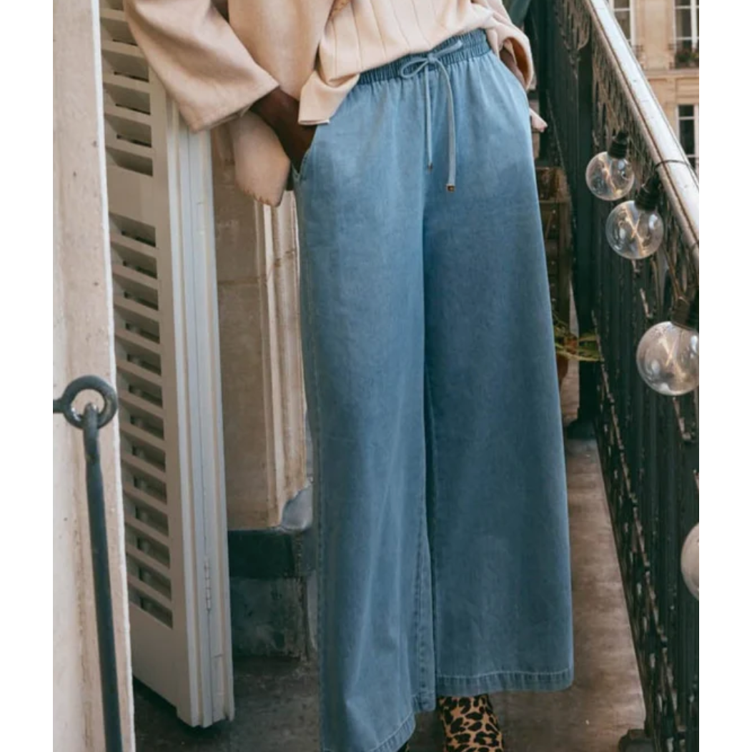 Pepi Wide Denim Pants

The Pepi Wide Denim Pant brings a fresh, modern feel to a timeless style with its wide-leg silhouette. Thoughtfully designed with inseam pockets for added practicality, it features an elastic waistband and an adjustable drawstring for a custom fit. Made from ultra-soft cotton denim, these pants are comfortable and versatile enough for any season. Wear them with a cosy knit and ballet flats for a laid-back, stylish look.