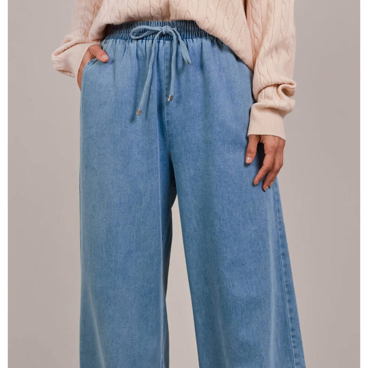 Pepi Wide Denim Pants

The Pepi Wide Denim Pant brings a fresh, modern feel to a timeless style with its wide-leg silhouette. Thoughtfully designed with inseam pockets for added practicality, it features an elastic waistband and an adjustable drawstring for a custom fit. Made from ultra-soft cotton denim, these pants are comfortable and versatile enough for any season. Wear them with a cosy knit and ballet flats for a laid-back, stylish look.