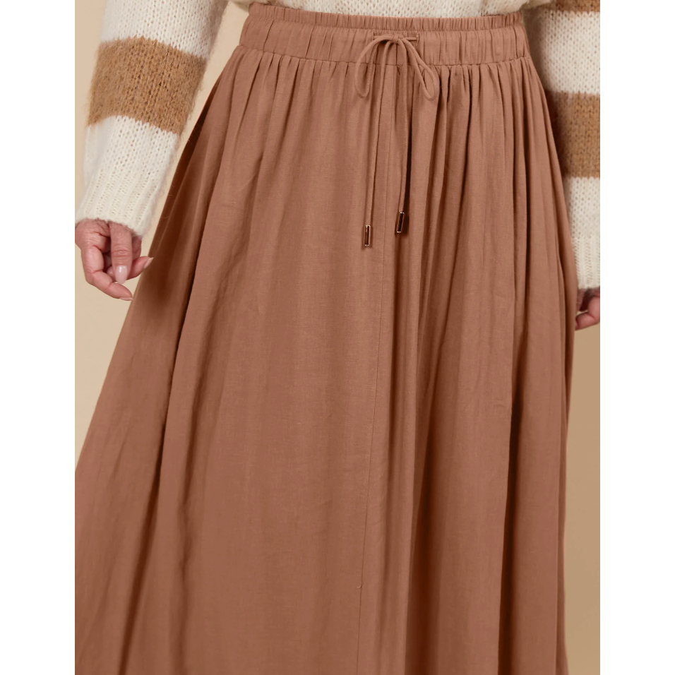 Venus Skirt -Toffee

The Venus Skirt seamlessly transitions from your 9-5 to 5-9 plans. Its flowing A-line silhouette adds a soft, feminine feel, enhanced by the comfortable elastic waist and adjustable drawstring. Available in our neutral seasonal palette, this skirt pairs effortlessly with your favourite wardrobe staples. Wear it with a classic knit and loafers for the office, then switch to a stylish blouse, boots, and statement accessories for a night out.