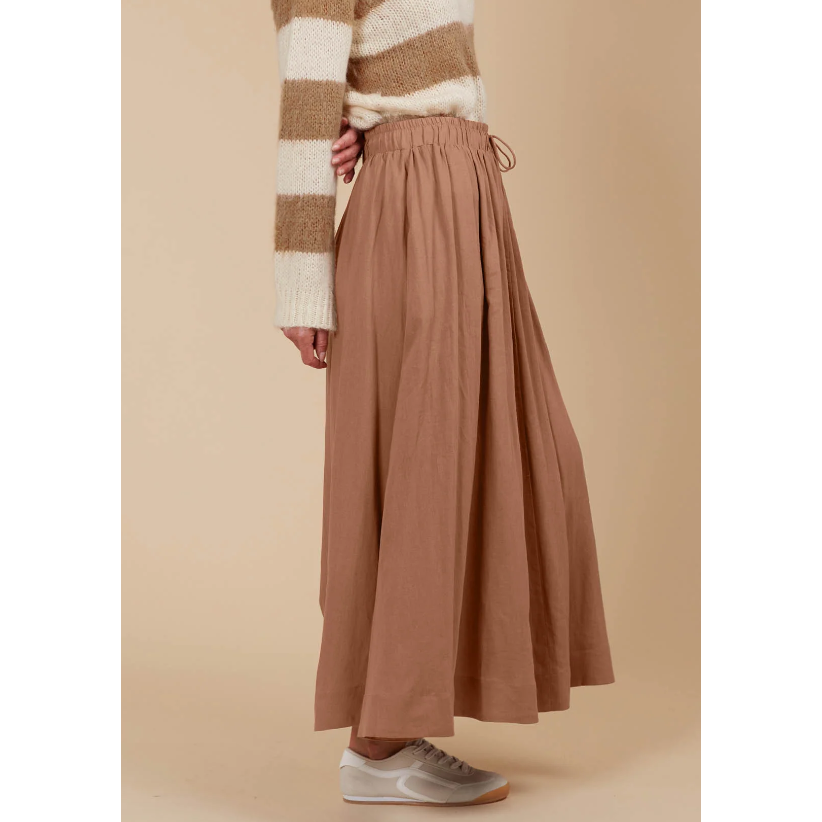 Venus Skirt -Toffee

The Venus Skirt seamlessly transitions from your 9-5 to 5-9 plans. Its flowing A-line silhouette adds a soft, feminine feel, enhanced by the comfortable elastic waist and adjustable drawstring. Available in our neutral seasonal palette, this skirt pairs effortlessly with your favourite wardrobe staples. Wear it with a classic knit and loafers for the office, then switch to a stylish blouse, boots, and statement accessories for a night out.