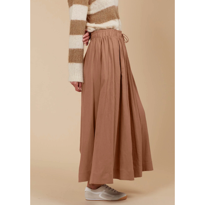 Venus Skirt -Toffee

The Venus Skirt seamlessly transitions from your 9-5 to 5-9 plans. Its flowing A-line silhouette adds a soft, feminine feel, enhanced by the comfortable elastic waist and adjustable drawstring. Available in our neutral seasonal palette, this skirt pairs effortlessly with your favourite wardrobe staples. Wear it with a classic knit and loafers for the office, then switch to a stylish blouse, boots, and statement accessories for a night out.