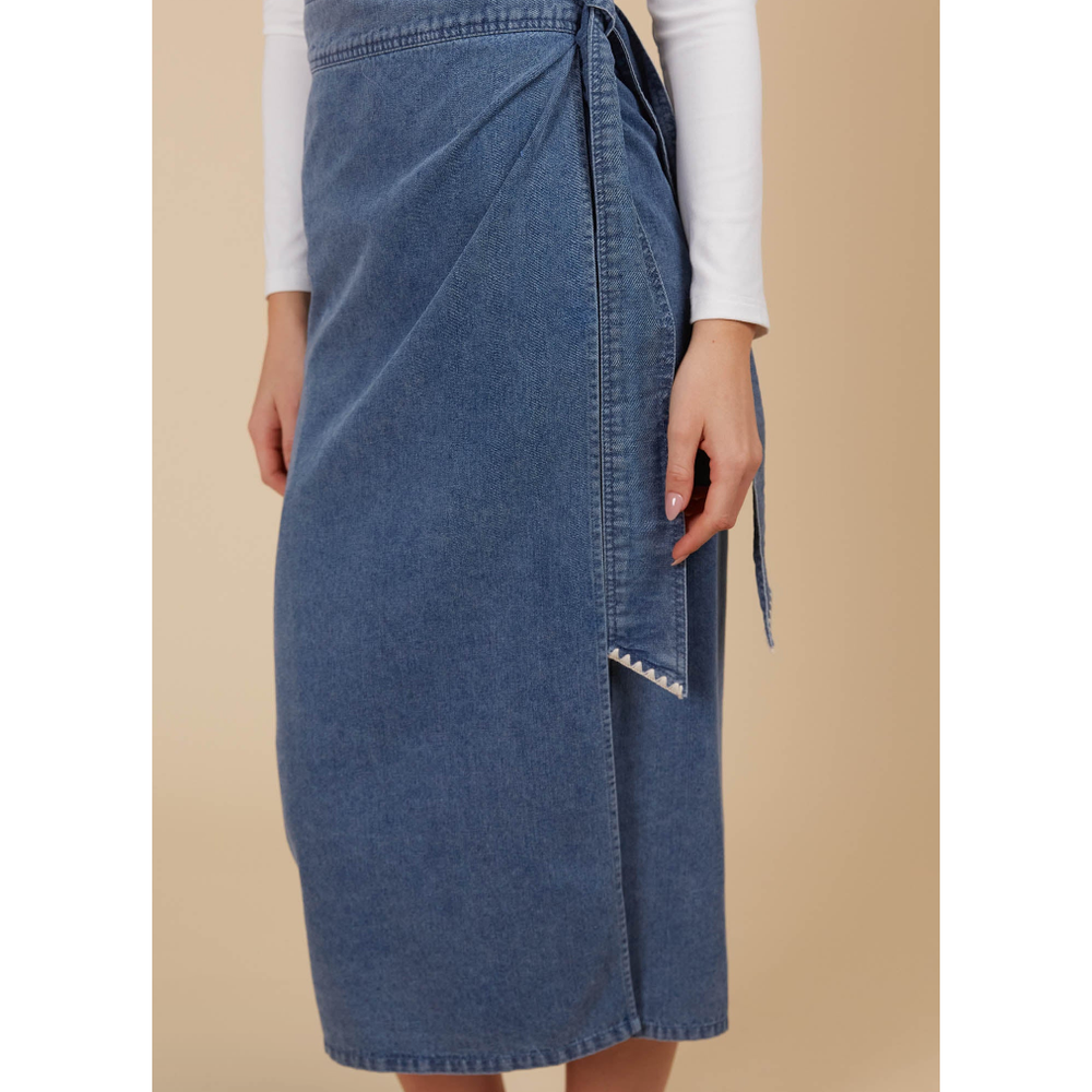 Freya Wrap Skirt -Denim

The Freya Wrap Skirt is destined to be a staple in your winter collection. With its graceful midi length and tailored wrap design, it strikes a balance between sophistication and versatility. The high-rise fit is cinched with a self-fabric belt, creating a streamlined profile that complements any setting. Style it with a long-sleeve top, sleek knee-high boots, and a classic trench coat for a chic ensemble that works from morning to evening.