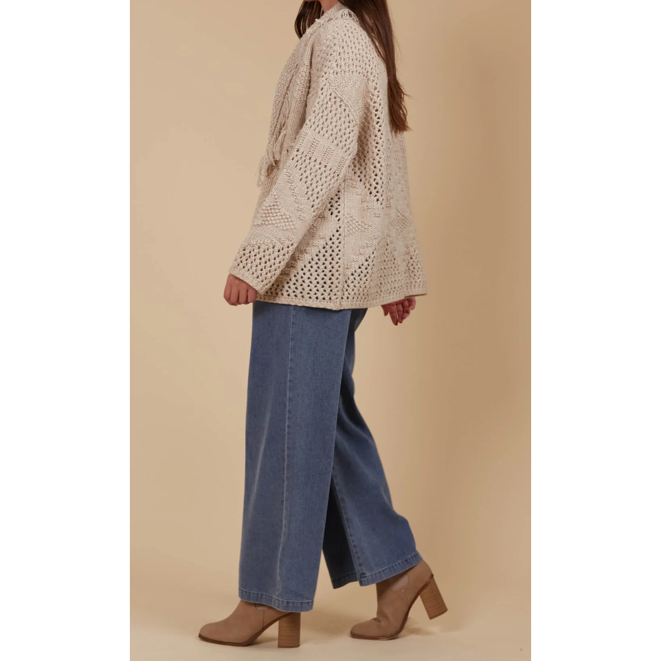 Luna Cardigan - Canvas

Answer the call of cosy days with the Luna Cardigan. Made from a luxurious wool blend, this cardigan combines ultimate softness with elevated style. Its standout features—a fringed lapel, open-front silhouette, and bold contrasting weave—make it perfect for relaxed moments at home or casual days on the go. Pair it with a t-shirt and relaxed-fit pants for a look that's as chic as it is comfortable.