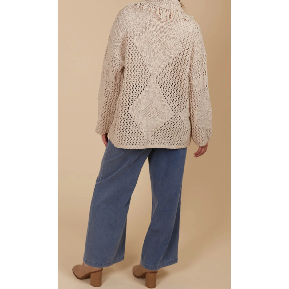 Luna Cardigan - Canvas

Answer the call of cosy days with the Luna Cardigan. Made from a luxurious wool blend, this cardigan combines ultimate softness with elevated style. Its standout features—a fringed lapel, open-front silhouette, and bold contrasting weave—make it perfect for relaxed moments at home or casual days on the go. Pair it with a t-shirt and relaxed-fit pants for a look that's as chic as it is comfortable.