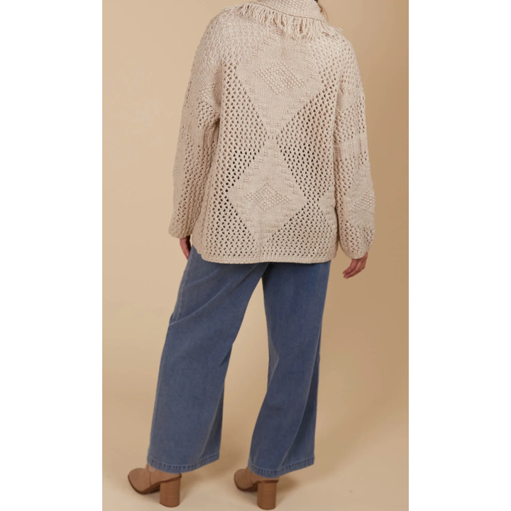Luna Cardigan - Canvas

Answer the call of cosy days with the Luna Cardigan. Made from a luxurious wool blend, this cardigan combines ultimate softness with elevated style. Its standout features—a fringed lapel, open-front silhouette, and bold contrasting weave—make it perfect for relaxed moments at home or casual days on the go. Pair it with a t-shirt and relaxed-fit pants for a look that's as chic as it is comfortable.