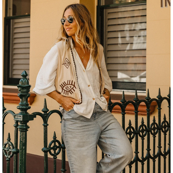 Boho Vest - Hazel

Introducing our Hazel Vest - with carefully thought out brown embroidery that adds depth and character. Crafted from lightweight cotton, it ensures a more flowy, laidback fit compared to your standard structured vest.Embrace the versatility by layering it over a shirt/dress showing your personal style!