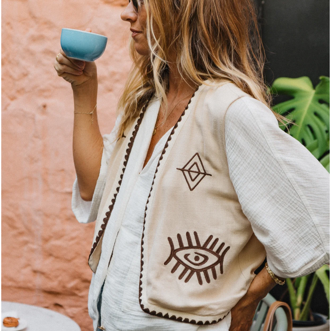 Boho Vest - Hazel

Introducing our Hazel Vest - with carefully thought out brown embroidery that adds depth and character. Crafted from lightweight cotton, it ensures a more flowy, laidback fit compared to your standard structured vest.Embrace the versatility by layering it over a shirt/dress showing your personal style!