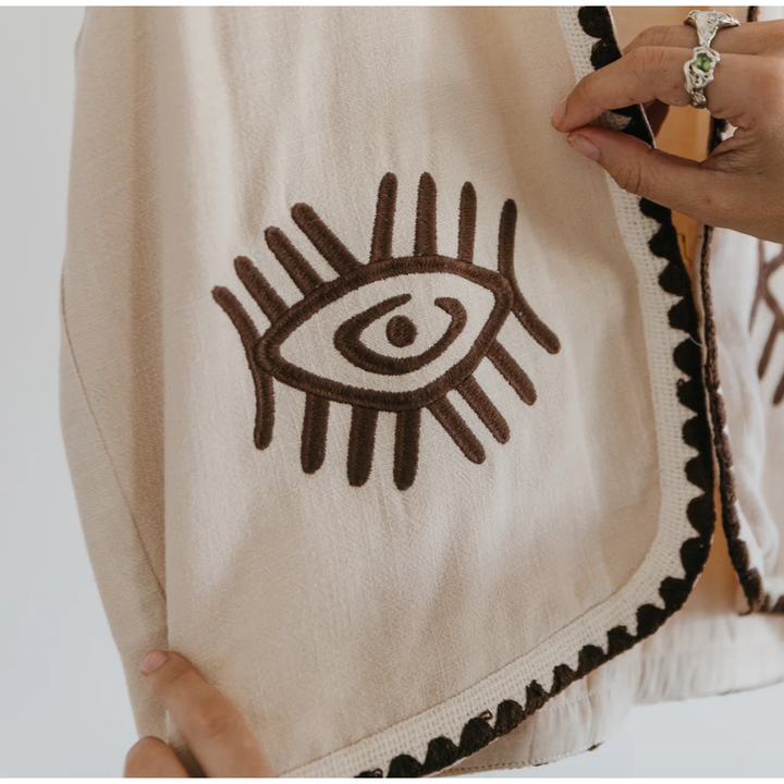 Boho Vest - Hazel

Introducing our Hazel Vest - with carefully thought out brown embroidery that adds depth and character. Crafted from lightweight cotton, it ensures a more flowy, laidback fit compared to your standard structured vest.Embrace the versatility by layering it over a shirt/dress showing your personal style!